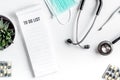 Medical equipment with stethoscope and to do list in doctor`s office on white desk background top view mock-up Royalty Free Stock Photo