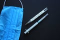 Medical equipments, close up photo. Plastic syringe, glass mercury thermometer, protective mask