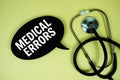 Medical Errors text on speech bubble with stethoscope on yellow background, Healthy concept Royalty Free Stock Photo