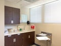 Medical exam room with cabinets at doctors office clinic