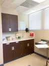 Medical exam room with cabinets at doctors office clinic