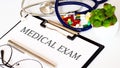 MEDICAL EXAM text and Background of Medicaments, Stethoscope Royalty Free Stock Photo