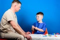 Medical examination. Boy cute child and his father doctor. Hospital worker. Medicine concept. Kid little doctor sit