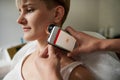 Medical examination at the oncological dermatological clinic. Doctor examining moles on the skin of a young woman. The concept of Royalty Free Stock Photo