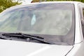 Medical face mask hanging on rear view mirror inside the car. for protect himself from bacteria and virus while driving a car.