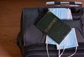 Medical face masks, passport on the background of the suitcase . Travel, vacation, Coronavirus, Covid-19, pandemic, quarantine, Royalty Free Stock Photo