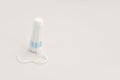 Medical female tampon. Hygienic white tampon for women. Cotton swab. Menstruation, means of protection