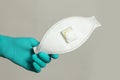 Medical filtering face piece mask in doctor or nurse hand, safety and virus protection concept