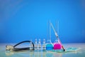 Medical flasks with colorful chemical reagents. Six ampoules with liquid, testing kit, syringe, mask and phonendoscope Royalty Free Stock Photo