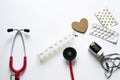 Medical flatlay composition on white background. Treating heart diseases. Prevention of complications. Life support equipment