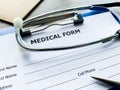 Medical form with patient data on doctor`s desk Royalty Free Stock Photo