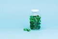 Medical green pill capsules in a glass bottle. Royalty Free Stock Photo