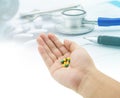 Medical, hand holding capsule pills, stethoscope, pills Royalty Free Stock Photo