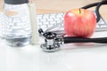 Medical health care concept consisting of stethoscope and apple fruit with bottled water Royalty Free Stock Photo