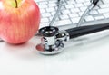 Medical health care concept with stethoscope and apple in background Royalty Free Stock Photo