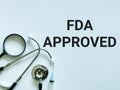 Phrase FDA Approved written on white background with stethoscope. Royalty Free Stock Photo