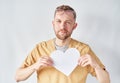 Young male doctor or nurse in uniform holding paper heart Royalty Free Stock Photo