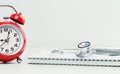 Medical or healthcare concept. stethoscope and spiral notepads with alarm clock Royalty Free Stock Photo