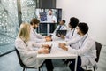 Medical and healthcare concept. Team of multiethnic diverse doctors scientists, watching online webinar with young Royalty Free Stock Photo