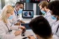 Medical and healthcare concept. Team of multiethnic diverse doctors scientists, wearing face masks, at online webinar Royalty Free Stock Photo