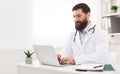 Doctor working with laptop computer in office Royalty Free Stock Photo