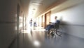 Medical hospital hallway with medical personnel and patients in motion blur sunlight effect