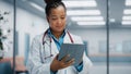 Medical Hospital Portrait: Confident African American Female Medical Doctor Using Digital Tablet Computer Royalty Free Stock Photo