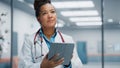 Medical Hospital Portrait: Confident African American Female Medical Doctor Using Digital Tablet Royalty Free Stock Photo