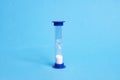 Medical hourglass on a blue background closeup