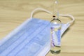 Medical hygiene mask and ampoule with medicine on the table