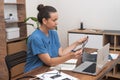 doctor meticulously examines ultrasound images, concurrently recording notes on her laptop. Royalty Free Stock Photo