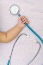 medical instruments stethoscope in hand of baby girl