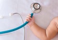 medical instruments stethoscope in hand of newborn baby girl Royalty Free Stock Photo