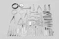 Medical instruments used for surgical operations, laid out on a gray background