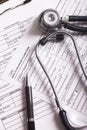 Medical insurance records, pen and Stethoscope