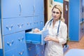 Medical intern searching for patient`s records in office. Card index Royalty Free Stock Photo