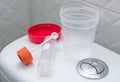 Medical kit for the sampling of feces and empty urine sample cup. Medical laboratory tests, concept. Royalty Free Stock Photo