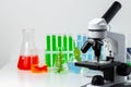 Medical laboratory. Scientific microscope with test tubes and plants