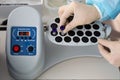 The medical laboratory technician places the tubes in the mini rotator.