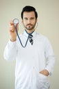 Medical male doctor dressed in uniform showing stethoscope and l Royalty Free Stock Photo