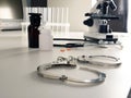 Medical malpractice concept. Laboratory desk in the hospital and handcuffs Royalty Free Stock Photo