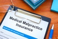 The Medical malpractice insurance application and clipboard. Royalty Free Stock Photo