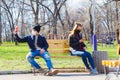 Medical mask as protection against coronavirus. a guy and a girl are sitting on a bench at a distance
