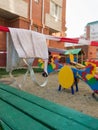 Medical mask with barricade tape on a closed kids playground in Russia. Concept during covid-19 coronavirus pandemic Royalty Free Stock Photo