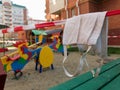 Medical mask with barricade tape on a closed kids playground in Russia. Concept covid-19 prevention coronavirus pandemic Royalty Free Stock Photo