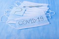 Medical mask with COVID-19 written on it, thermometer and sticker with question mark