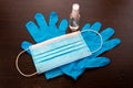 Medical mask, disposable gloves and antiseptic gel on a black