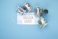 Medical mask with dollars and the words paid sick leave on a blue background Royalty Free Stock Photo