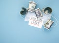 Medical mask with dollars and the words paid sick leave on a blue background Royalty Free Stock Photo