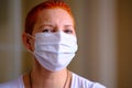Medical mask on the girl`s face. Personal protective equipment. The concept of preventing the spread of the virus during an